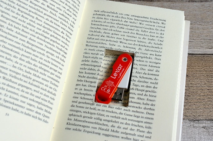 An open book with a red swiss army knife